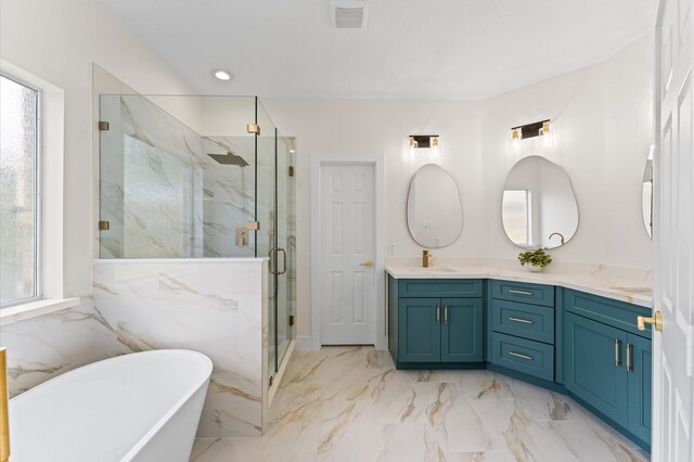 31318 Bearing Star Ln, Tomball, TX 77375 - bathroom with double vanity, a freestanding tub, a marble finish shower, and plenty of natural light