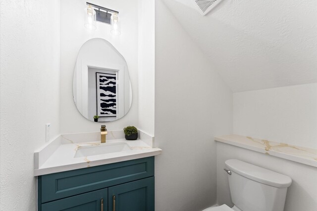 31318 Bearing Star Ln, Tomball, TX 77375 - bathroom with toilet, vanity, and vaulted ceiling