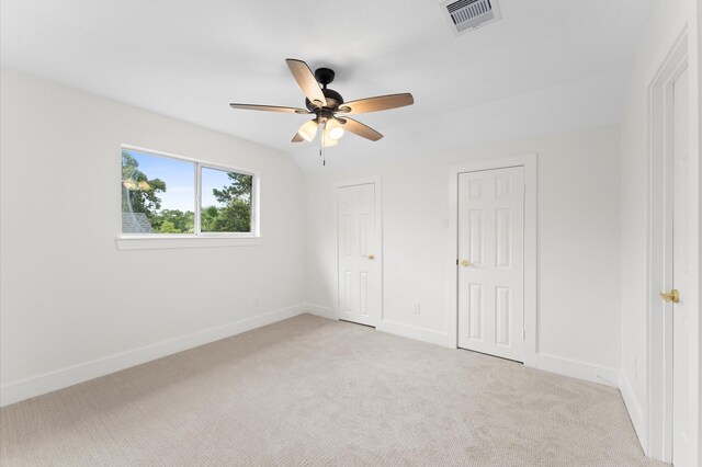 31318 Bearing Star Ln, Tomball, TX 77375 - unfurnished bedroom featuring light colored carpet, baseboards, two closets, and a ceiling fan