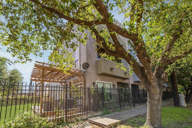 1814 Rosalie St, Houston, TX 77004 - view of home's exterior with a fenced front yard, stucco siding, and a pergola