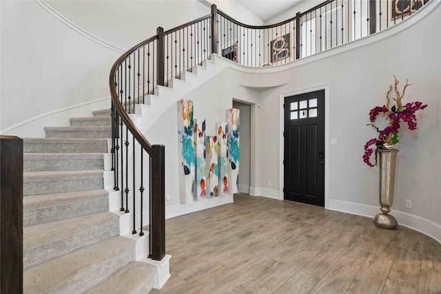 17464 Chestnut Cove Dr, Conroe, TX 77302 - entrance foyer with stairs, wood finished floors, baseboards, and a towering ceiling