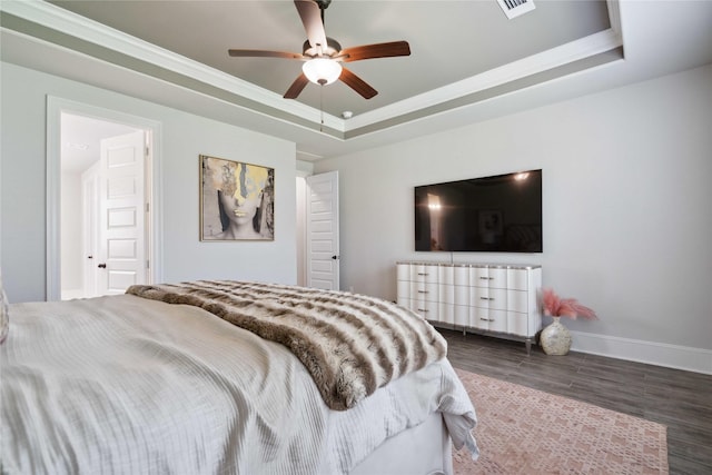 17464 Chestnut Cove Dr, Conroe, TX 77302 - bedroom featuring a raised ceiling, baseboards, wood finished floors, crown molding, and a ceiling fan