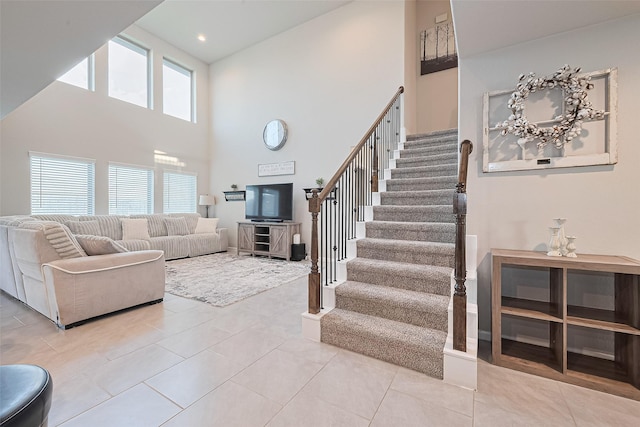 3415 Sicily Island Ln, Katy, TX 77494 - living room featuring a high ceiling, stairs, and light tile patterned floors