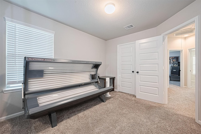 3415 Sicily Island Ln, Katy, TX 77494 - living area with carpet flooring, a textured ceiling, a tanning bed, and baseboards