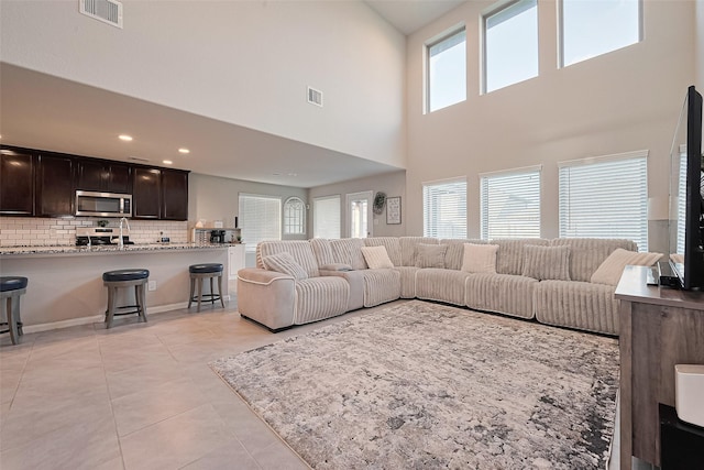 3415 Sicily Island Ln, Katy, TX 77494 - living area featuring light tile patterned floors, a high ceiling, and recessed lighting