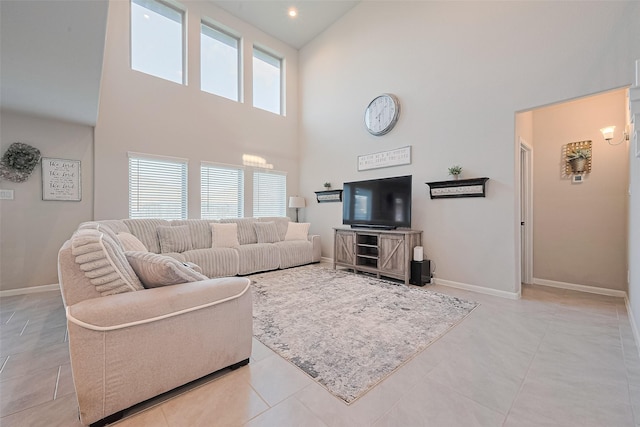 3415 Sicily Island Ln, Katy, TX 77494 - living area with a high ceiling, baseboards, and light tile patterned floors