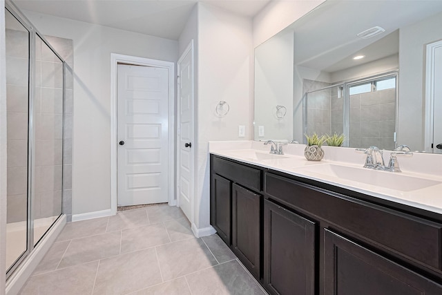 3415 Sicily Island Ln, Katy, TX 77494 - full bathroom featuring a stall shower, double vanity, tile patterned floors, and baseboards