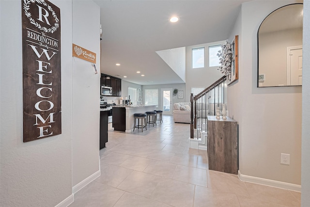 3415 Sicily Island Ln, Katy, TX 77494 - corridor featuring recessed lighting, baseboards, light tile patterned floors, and stairs