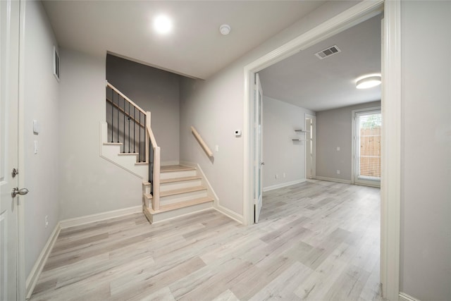 409 W 17th St Unit A, Houston, TX 77008 - entryway featuring light wood-style floors, stairs, and baseboards