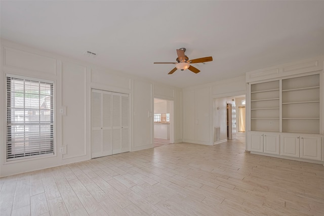 5210 Holly View Dr, Houston, TX 77091 - spare room featuring a ceiling fan, a decorative wall, and light wood-type flooring