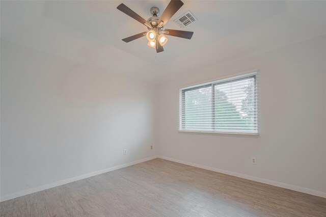 5210 Holly View Dr, Houston, TX 77091 - empty room with wood finished floors, a ceiling fan, and baseboards