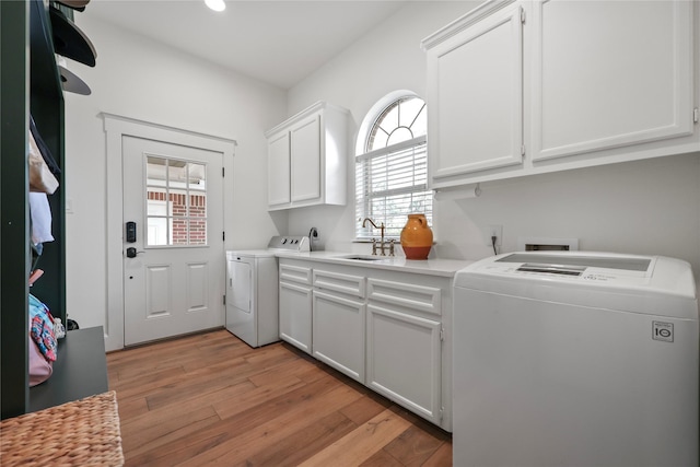 22810 Glenmont Estates Blvd, Magnolia, TX 77355 - laundry area featuring washer and dryer, cabinet space, light wood-type flooring, and recessed lighting