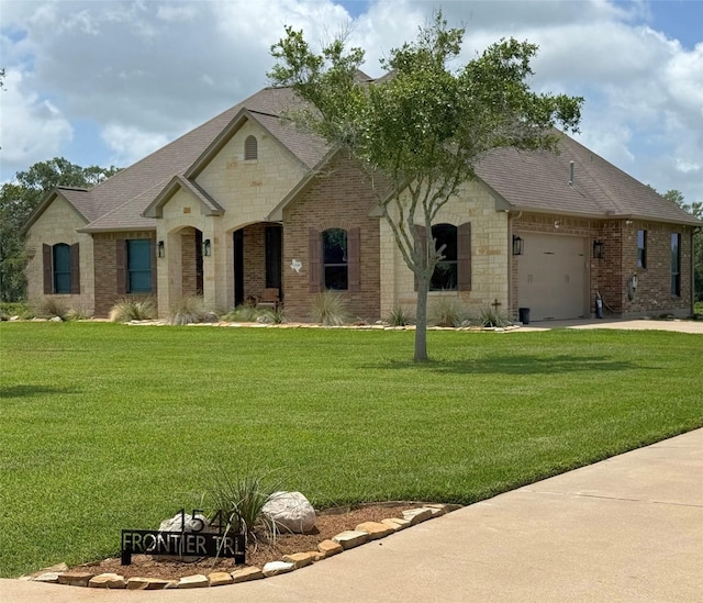 1549 Frontier Trl, Angleton, TX 77515 - french country home featuring brick siding, a garage, a shingled roof, and a front yard