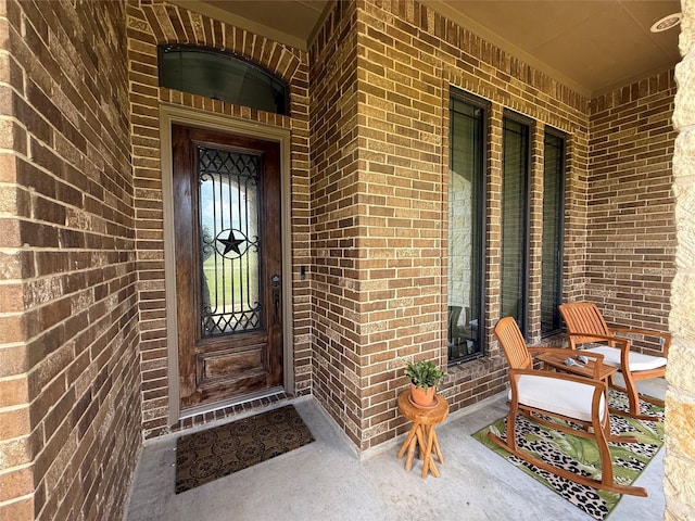 1549 Frontier Trl, Angleton, TX 77515 - property entrance with a porch and brick siding