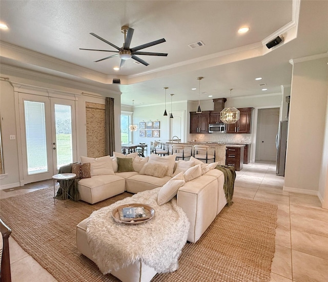 1549 Frontier Trl, Angleton, TX 77515 - living room featuring ceiling fan, light tile patterned floors, a raised ceiling, crown molding, and recessed lighting