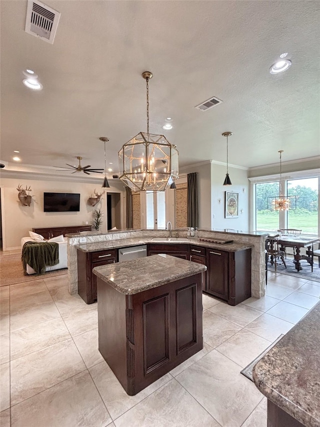 1549 Frontier Trl, Angleton, TX 77515 - kitchen with a chandelier, a large island with sink, stainless steel dishwasher, open floor plan, and crown molding
