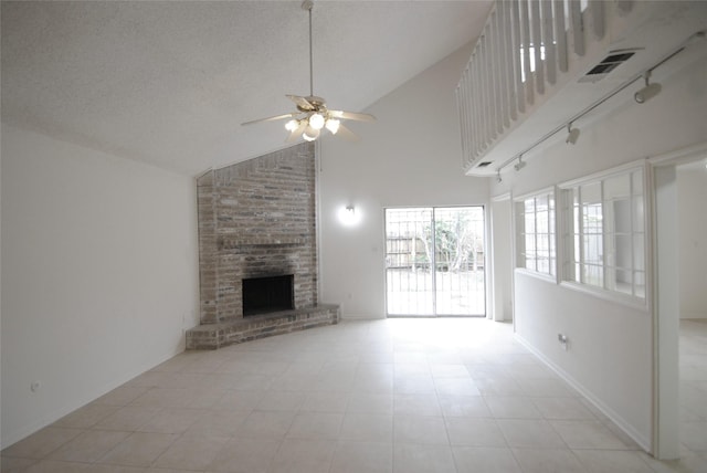 6207 Grandvale Dr, Houston, TX 77072 - unfurnished living room featuring high vaulted ceiling, a ceiling fan, a brick fireplace, and a textured ceiling