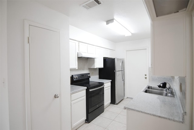 6207 Grandvale Dr, Houston, TX 77072 - kitchen with black electric range oven, under cabinet range hood, tasteful backsplash, light countertops, and freestanding refrigerator