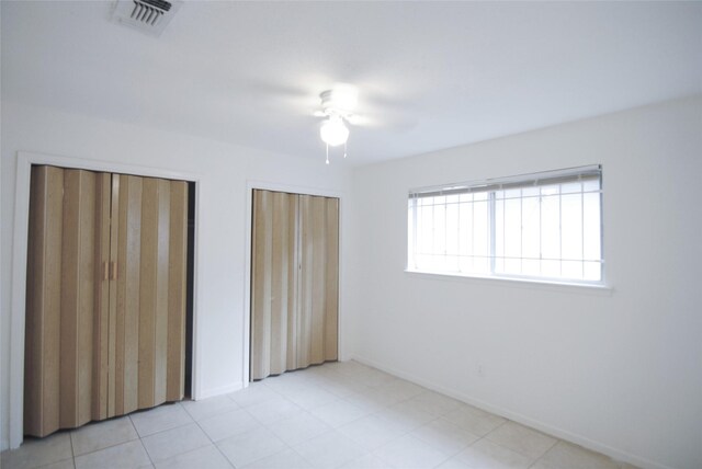 6207 Grandvale Dr, Houston, TX 77072 - unfurnished bedroom featuring two closets and ceiling fan