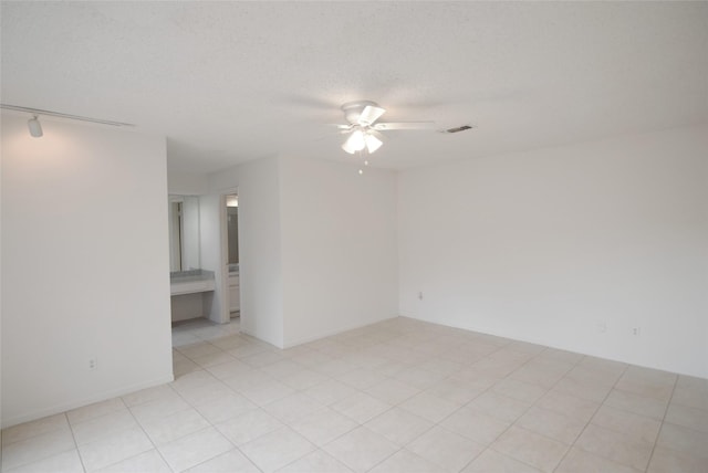 6207 Grandvale Dr, Houston, TX 77072 - empty room featuring a ceiling fan, rail lighting, and a textured ceiling