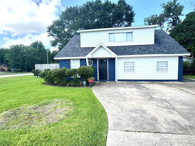 5301 Hemlock Dr, Baytown, TX 77521 - view of front of home featuring a shingled roof, driveway, and brick siding