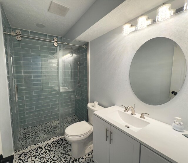 5301 Hemlock Dr, Baytown, TX 77521 - bathroom featuring vanity, a shower stall, toilet, tile patterned flooring, and a textured ceiling