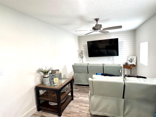 5301 Hemlock Dr, Baytown, TX 77521 - living area featuring ceiling fan, wood finished floors, a textured ceiling, and baseboards