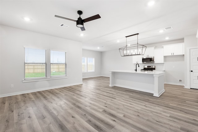 6426 Bolinas Ct, Rosharon, TX 77583 - unfurnished living room with a sink, recessed lighting, ceiling fan, light wood-type flooring, and baseboards