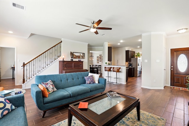 3519 Barkers Run Dr, Houston, TX 77084 - living room featuring crown molding, a ceiling fan, wood finish floors, stairs, and baseboards