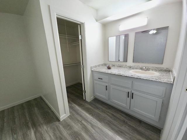 2806 W Greens Rd, Houston, TX 77067 - bathroom with vanity, wood finished floors, a spacious closet, and baseboards