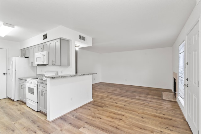 6500 Sands Point Dr Unit 107, Houston, TX 77074 - kitchen featuring white appliances, light wood finished floors, gray cabinetry, open floor plan, and light stone counters