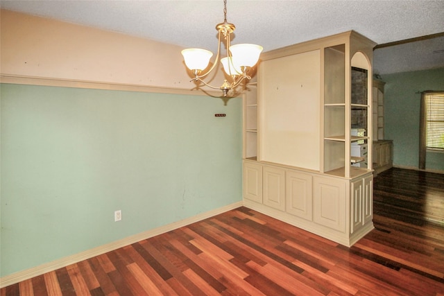 21 Edgewood Forest Ct, The Woodlands, TX 77381 - unfurnished room with dark wood-style flooring, a chandelier, and baseboards