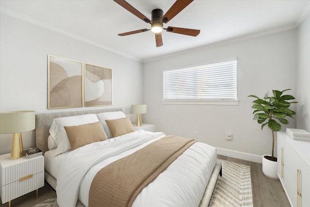 5542 Holly St Unit 205, Houston, TX 77081 - bedroom featuring crown molding, wood finished floors, and a ceiling fan