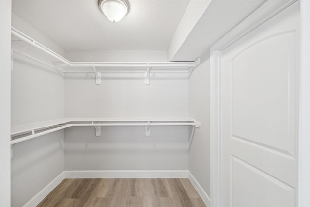 5542 Holly St Unit 205, Houston, TX 77081 - walk in closet with wood finished floors