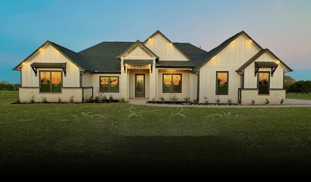 197 Sandpiper Dr, New Waverly, TX 77358 - modern farmhouse style home featuring board and batten siding, a front yard, and a shingled roof