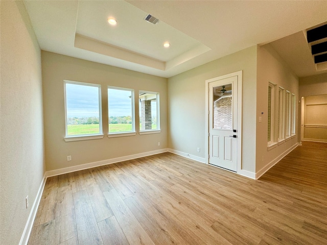 197 Sandpiper Dr, New Waverly, TX 77358 - empty room featuring wood finished floors, recessed lighting, baseboards, and a raised ceiling