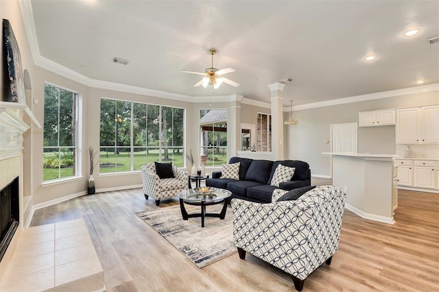 14810 Cantwell Bnd, Cypress, TX 77429 - living area featuring a fireplace, a ceiling fan, baseboards, light wood-style floors, and crown molding