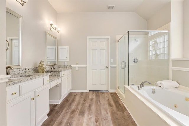 14810 Cantwell Bnd, Cypress, TX 77429 - bathroom with double vanity, a whirlpool tub, a shower stall, wood finished floors, and lofted ceiling