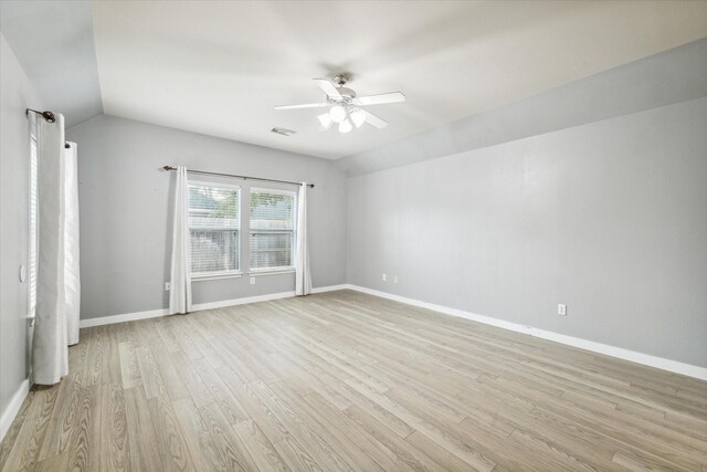 28519 Peper Hollow Ln, Spring, TX 77386 - spare room with a ceiling fan, light wood-style floors, baseboards, and vaulted ceiling