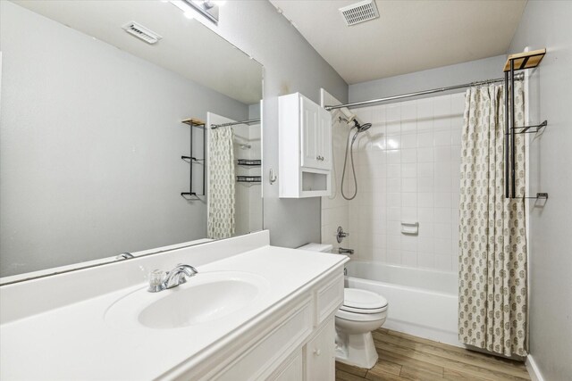 28519 Peper Hollow Ln, Spring, TX 77386 - full bath featuring vanity, toilet, shower / bath combo, and wood finished floors