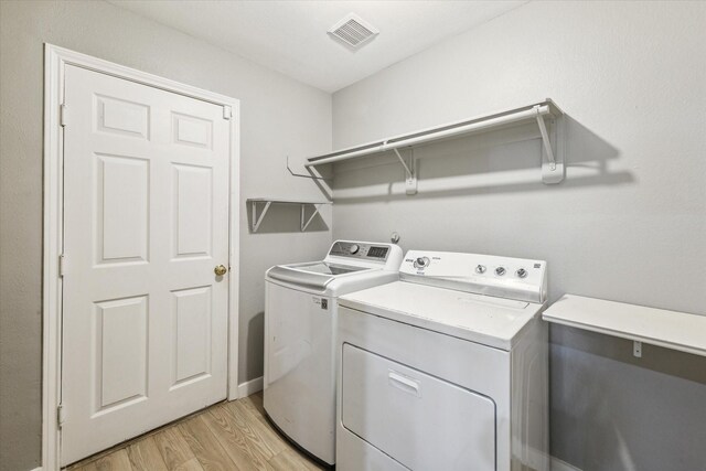 28519 Peper Hollow Ln, Spring, TX 77386 - laundry area featuring separate washer and dryer and light wood-style flooring