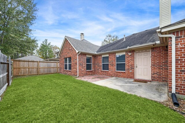 28519 Peper Hollow Ln, Spring, TX 77386 - rear view of property with a chimney, brick siding, roof with shingles, and a patio area