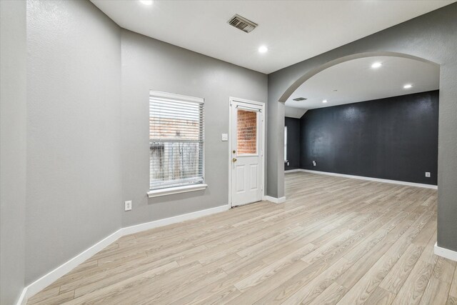 28519 Peper Hollow Ln, Spring, TX 77386 - empty room featuring arched walkways, light wood-type flooring, baseboards, and recessed lighting