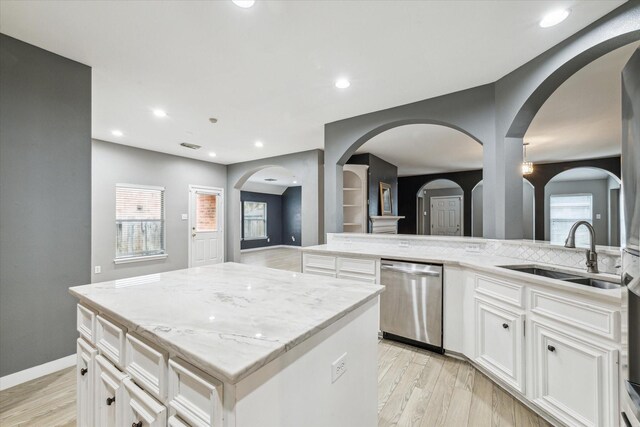 28519 Peper Hollow Ln, Spring, TX 77386 - kitchen featuring dishwasher, a sink, light stone countertops, light wood-style flooring, and recessed lighting
