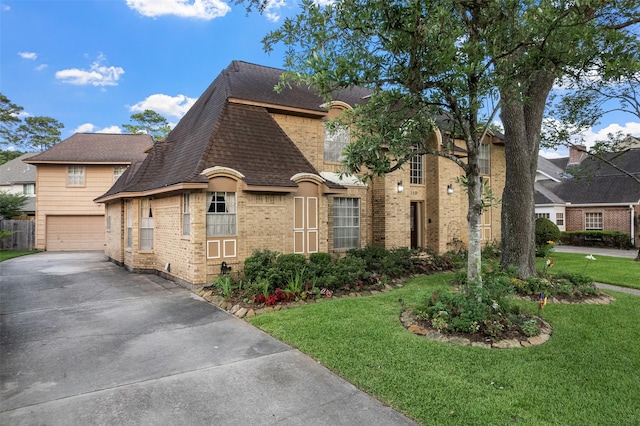 15118 Terrace Oaks Dr, Houston, TX 77068 - french country inspired facade featuring driveway, a front yard, brick siding, a garage, and roof with shingles