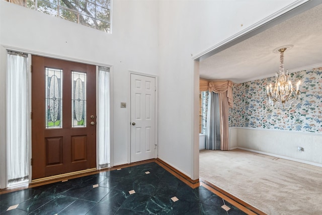 15118 Terrace Oaks Dr, Houston, TX 77068 - foyer entrance featuring a chandelier, a wainscoted wall, and wallpapered walls
