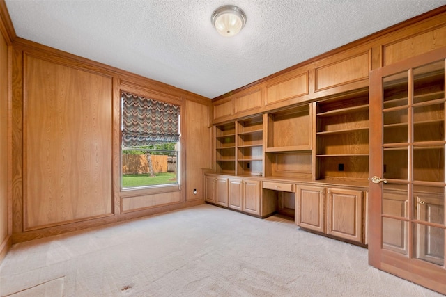 15118 Terrace Oaks Dr, Houston, TX 77068 - unfurnished office featuring built in study area, a textured ceiling, and light carpet