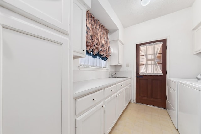 15118 Terrace Oaks Dr, Houston, TX 77068 - laundry area featuring cabinet space, washer and dryer, and a textured ceiling