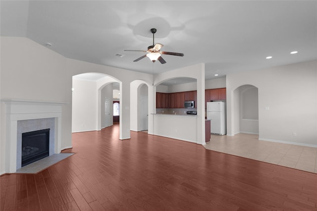 13406 Georgia Hollow Ct, Rosharon, TX 77583 - unfurnished living room with a ceiling fan, light wood finished floors, a fireplace, recessed lighting, and baseboards