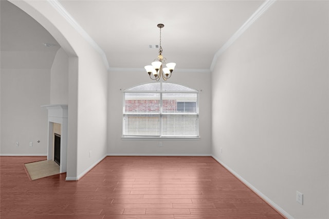 13406 Georgia Hollow Ct, Rosharon, TX 77583 - unfurnished room featuring a chandelier, ornamental molding, wood finished floors, baseboards, and a fireplace with flush hearth